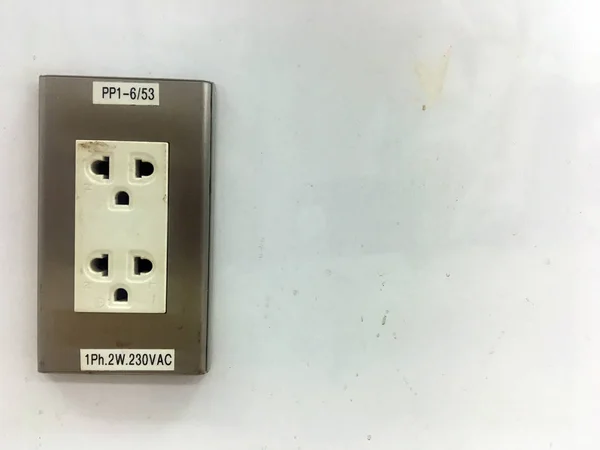 Electric current plug on the cement wall
