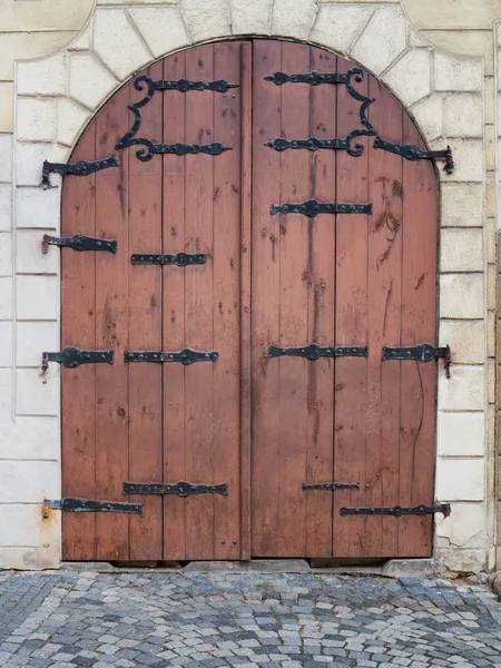 Wyblakły, drewniane drzwi w centrum zabytkowego miasta. Praga. — Zdjęcie stockowe