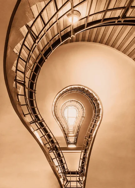 Light bulb in the shape of a cubist staircase in a historical building of Prague colored in historic brown colors. Stock Image