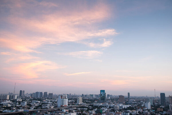 Aerial view of urban city skyline at sunrise, beautiful sky and buildings in downtown of Bangkok, cityscape background or backdrop in vintage sweet tone and modern retro style