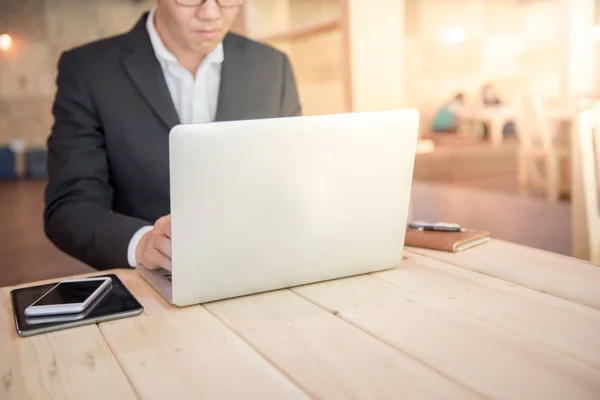 Jeune homme d'affaires travaillant avec un ordinateur portable dans un café — Photo