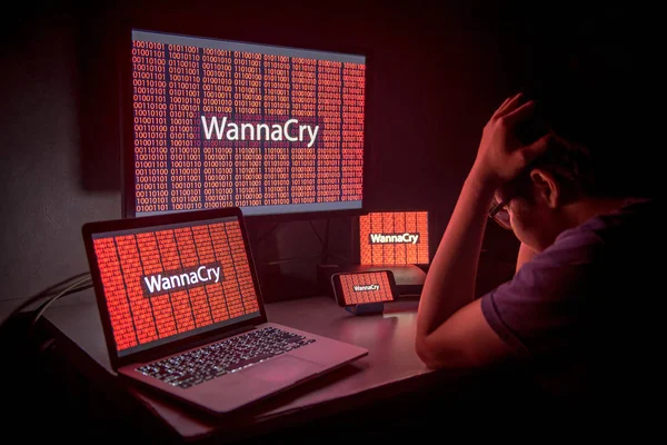 Young Asian male frustrated by WannaCry ransomware attack — Stock Photo, Image