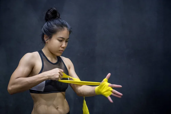 Boxer woman wearing yellow strap on wrist — Stock Photo, Image