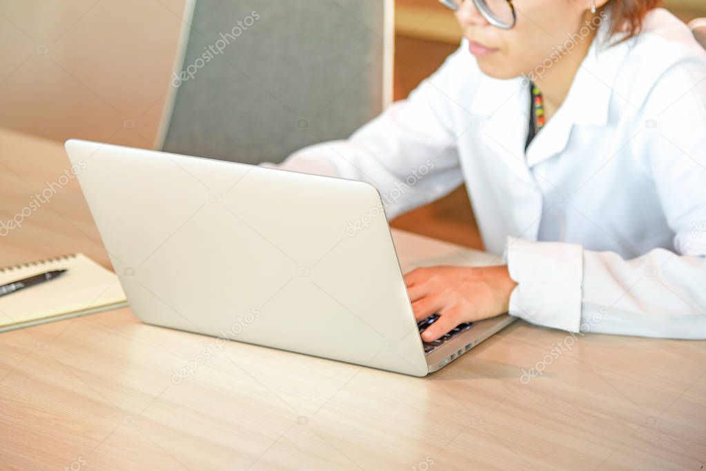 Businesswoman with laptop in workspace