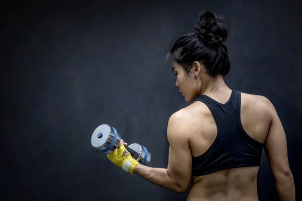 Young Asian woman lifting dumbbell, weight training — Stock Photo, Image