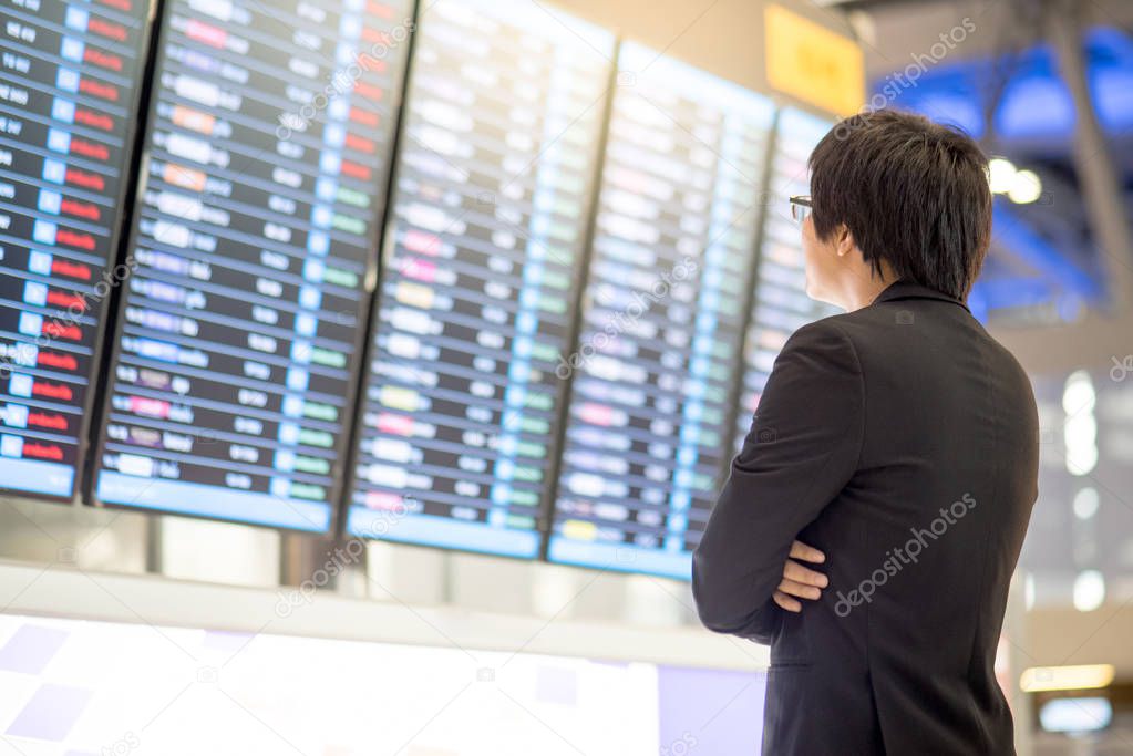 Young asian businessman checking his flight