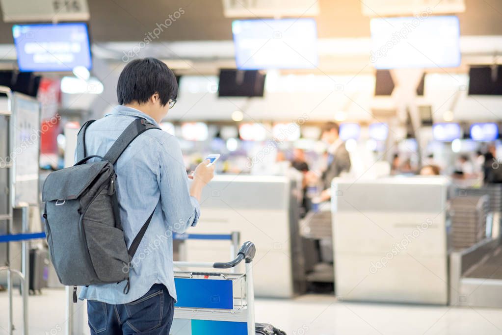 young asian man waiting for airport check in