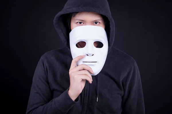 Mystery man holding white mask for hide his face — Stock Photo, Image