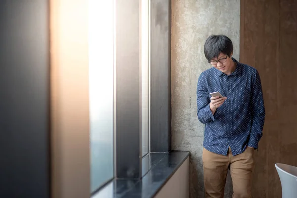 Jonge Aziatische zakenman met behulp van slimme telefoon — Stockfoto