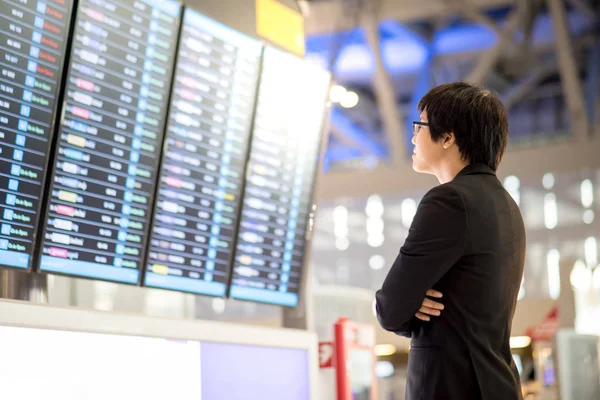 Young asian businessman checking his flight