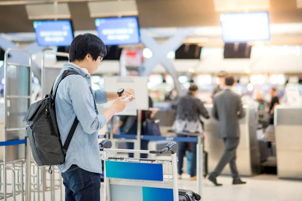 Havaalanı check-in için bekleyen genç Asyalı adam — Stok fotoğraf