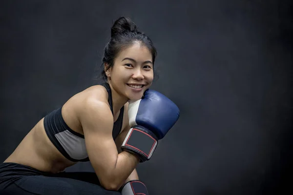 young Asian woman posing with boxing gloves