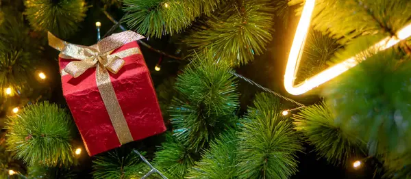 Red Christmas gift box on Christmas tree