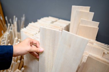 Kırtasiyede balsa tahtası seçen bir erkek.