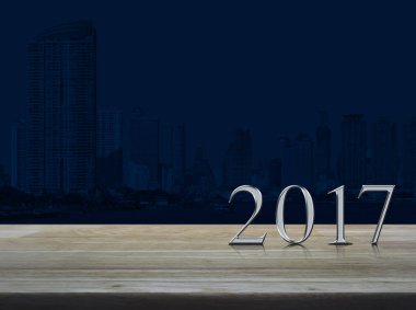 Mutlu yeni yıl 2017 gümüş metal metin şehir üzerinde ahşap tablo
