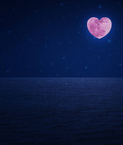Pink moon love heart shape over fantasy sky and sea, Valentines day concept