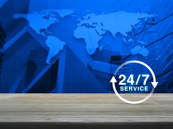 24 hours service icon on wooden table over world map and city to — Stock Photo, Image