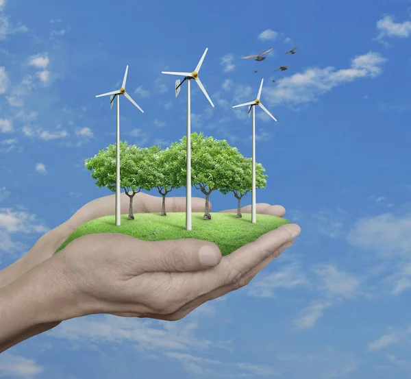 Wind turbines, grass and trees in human hands over blue sky — Stock Photo, Image