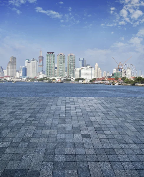 An empty scene of stone tile floor with modern office city tower — Stock Photo, Image