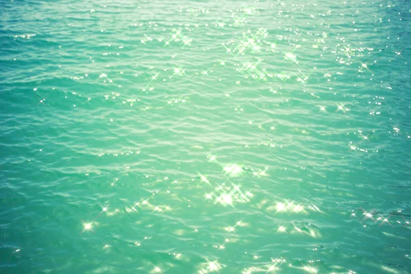 Sea background - turquoise water with glare of light — Stock Photo, Image