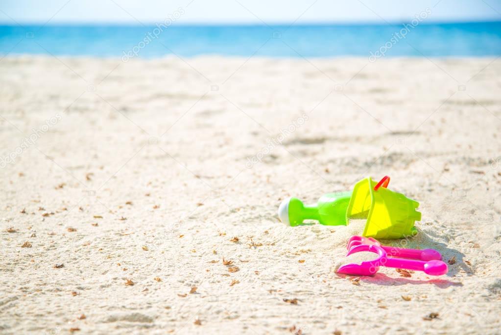 Children's beach toys - buckets, spade and shovel on sand on a s