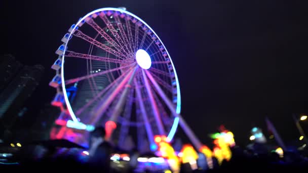 HONG KONG FEBRUARY 2016: Ferris wheel illuminated at night in Hong Kong — Stock Video