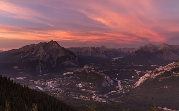 Yukarıda da görüleceği onu çevreleyen dağ ile gün batımında Banff