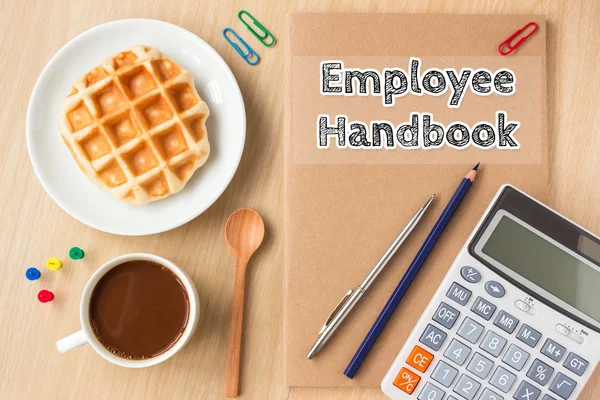 Employee handbook text message on paper book and office supplies, pen, coffee on wood desk , copy space / business concept / view from above, top view — Stock Photo, Image