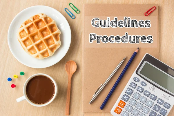 guidelines, procedures text message on paper book and office supplies, pen, coffee on wood desk , copy space / business concept / view from above, top view