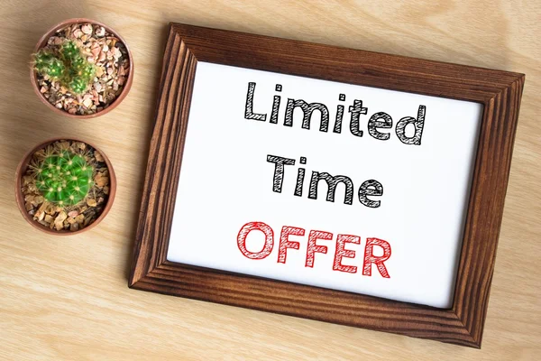 limited time offer, text message on wood frame board on wood table / business concept / Top view