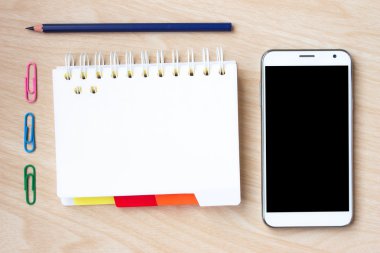 blank notepad with pen and pencil on wooden background