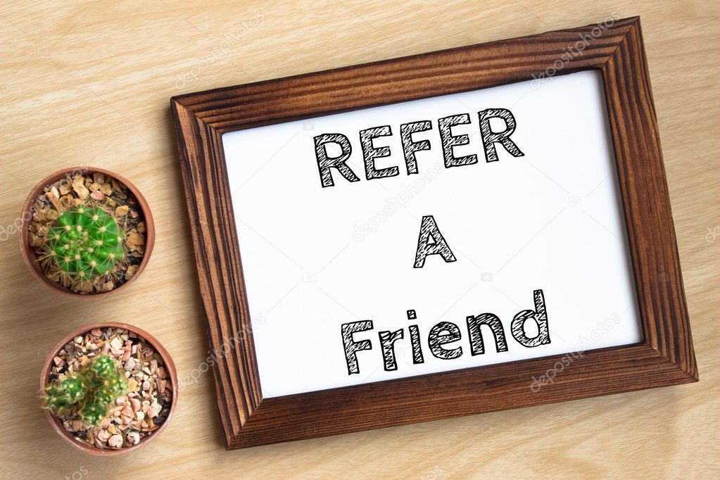 refer a friend, text message on wood frame board on wood table / business concept / Top view