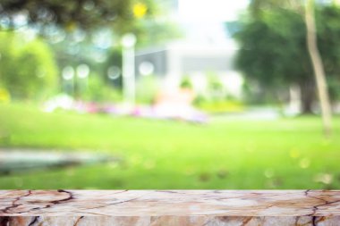 white marble stone countertop or table on backdrop blurred nature background / for display or montage your products / empty marble background concept 