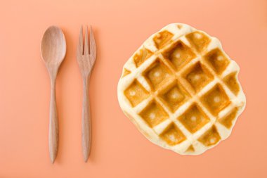 waffle with chocolate and caramel on a yellow background