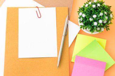 blank white note and sticky notes on wooden background