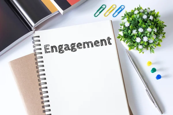 Engagement word message on white paper book and copy space on white desk / business concept / top viewengagement word message on white paper book and copy space on white desk / business concept / top view — Stock Photo, Image
