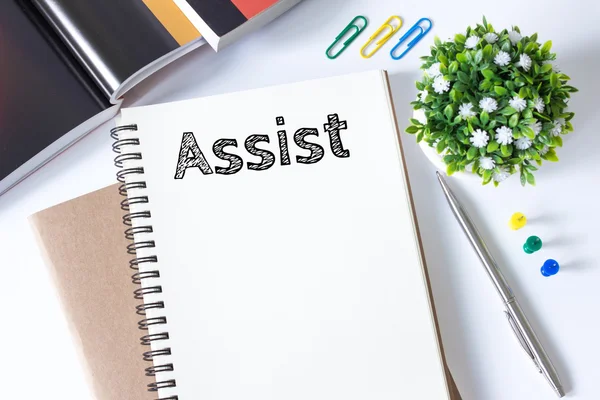 Assist message text on white paper book on white desk / business concept / top view — Stock Photo, Image