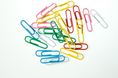 multicolored paperclips in paper clips on white background