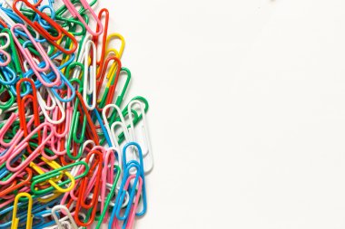 Beyaz arkaplanda renkli ataçlar