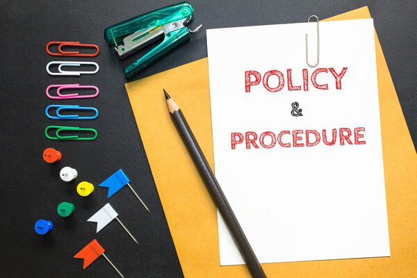 Policy & procedure, message on the white paper / business concept
