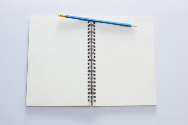 blank notepad with pencil and pen on white background
