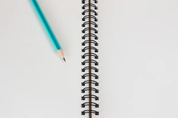 Open blank sketchbook with pencil isolated on white background