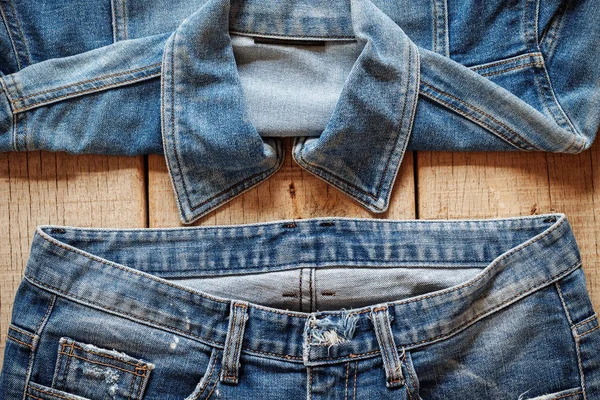 Old jeans on wooden. — Stock Photo, Image