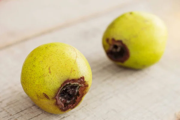 Pear is going to rot on wooden. — Stock Photo, Image