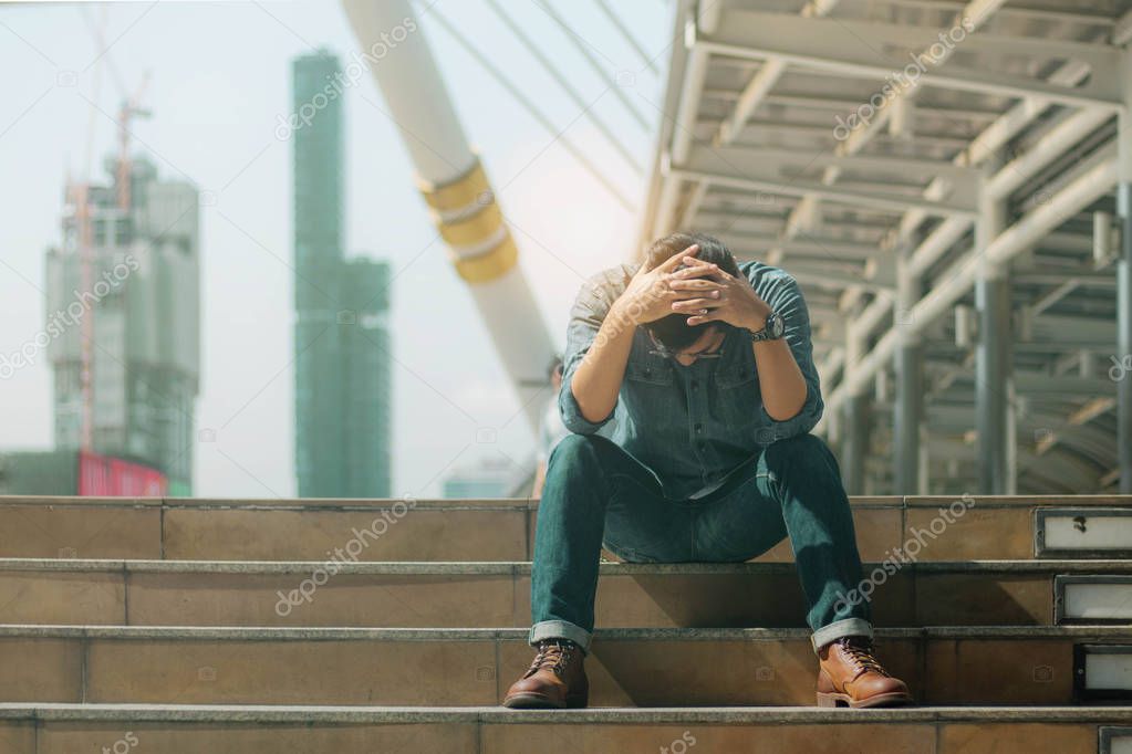 Young man with failure on stairway.