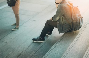 Merdivenlerde oturan genç turizm.