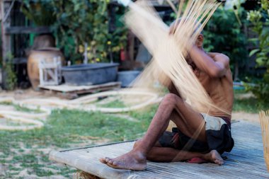 Old man are weaving with blurred.