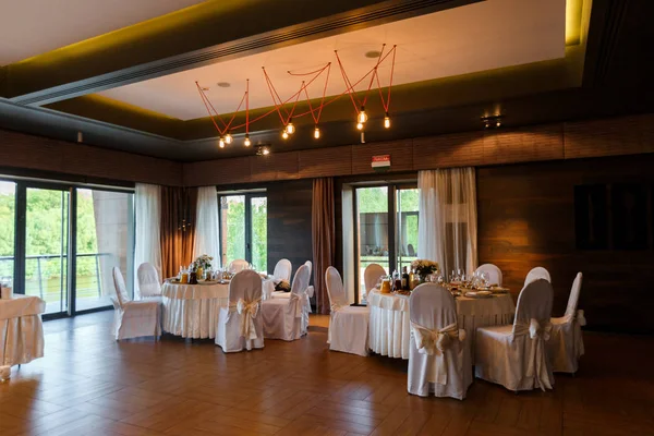Modern banquet hall. Decorated tables, elegant setting, beautifu