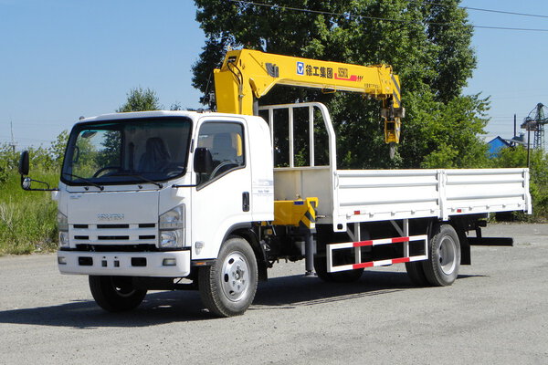 White Isuzu flatbed truck with yellow crane arm is in the parking lot - Russia, Moscow, 30 August 2016