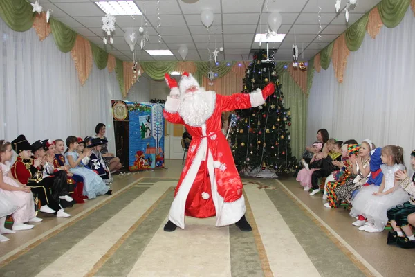 Les petits enfants ressemblent au Père Noël dansant en vacances à la maternelle - Russie, Moscou, 17 décembre 2016 — Photo